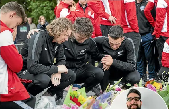  ?? ALDEN WILLIAMS/STUFF ?? New Zealand futsal (indoor football) players grieve for Atta Elayyan at the Deans Avenue cordon in Christchur­ch yesterday.