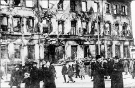  ?? Associated Press ?? People crowd the street in front of the ruins of the Nikitsky Gate to the Imperial Palace in Petrograd (St. Petersburg and Leningrad), Russia, shortly after the outbreak of the Russian Revolution, February. 1917.