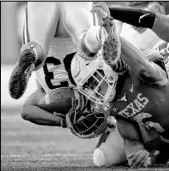  ?? Nick Wagner The Associated Press ?? Texas linebacker Juwan Mitchell upends Kansas State running back Tyler Burns during the Longhorns’ 27-24 win Saturday at Memorial Stadium.