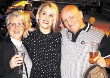  ??  ?? Andy Betts, pictured with wife Lesley and daughter Laura, was a popular figure on the Kent darts scene and his actions at Benenden School have been hailed as heroic