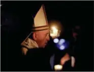  ?? GREGORIO BORGIA - THE ASSOCIATED PRESS ?? Pope Francis holds a candle as he presides over a solemn Easter vigil ceremony in St. Peter’s Basilica at the Vatican, Saturday.