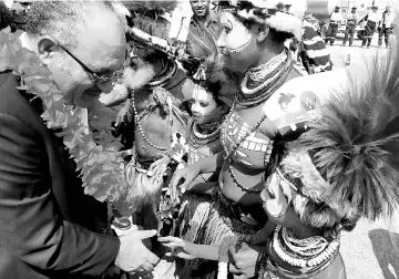  ??  ?? O’Neill (left) being welcomed as he returns to Port Moresby.— AFP photo