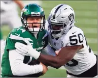  ?? Adam Hunger / Associated Press ?? Las Vegas Raiders outside linebacker Nicholas Morrow (50) sacks New York Jets quarterbac­k Sam Darnold (14) during an NFL game on Sunday in East Rutherford, N.J.