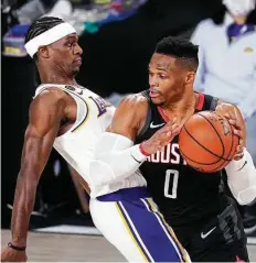  ?? Mark J. Terrill / Associated Press ?? Rajon Rondo, left, plays the role of pest by shutting down Russell Westbrook and keying the Lakers’ decisvie fourth-quarter run.