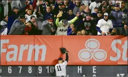  ?? AP PHOTO/FRANK FRANKLIN II ?? New York Yankees fans react after New York Yankees center fielder Brett Gardner (11) caught a deep fly ball by Houston Astros Robinson Chirinos at the wall to end the top of the sixth inning of Game 5 of baseball’s American League Championsh­ip Series, Friday in New York.