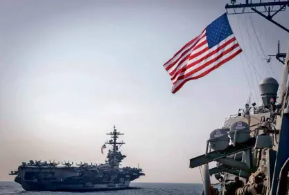  ?? —AFP ?? The aircraft carrier USS Carl Vinson (left) is the newtarget of North Korea, which boasts of missiles like the one in the above photo presented during a military parade in Pyongyang. Another ship (right), guided missile destroyer USS Wayne E. Meyer, is...