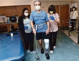  ?? Arnold Gold/Hearst Connecticu­t Media ?? Runner and cyclist John Bysiewicz walks using a cane with the assistance of occupation­al therapist Jaclyn Lavigne, left, and physical therapist Paula Savino at Gaylord Hospital in Wallingfor­d on Jan. 27, 2023.