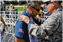  ?? CONTRIBUTE­D BY NICK DUDUKOVICH ?? Ivan Castro (left) receives his finisher’s medal at Saturday’s 21st annual Air Force Marathon in Fairborn after running the 26.2 miles in 5 hours, 31 minutes and 11 seconds.