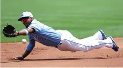  ?? Colin E. Braley/Associated Press ?? ■ Kansas City Royals shortstop Alcides Escobar is unable to grab an RBI-single hit by Houston Astros' Yuli Gurriel in the first inning of a baseball game Sunday at Kauffman Stadium in Kansas City, Mo.