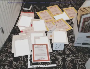  ?? DEPARTMENT OF JUSTICE VIA AP ?? This image contained in a court filing by the Department of Justice in 2022, and redacted by in part by the FBI, shows a photo of documents seized during the Aug. 8 search by the FBI of former President Donald Trump’s Mar-a-Lago estate in Florida.