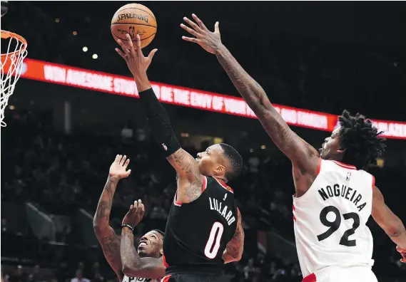  ?? STEVE DYKES/THE ASSOCIATED PRESS ?? Raptors centre Lucas Nogueira, right, stood out all over the court with his stellar play Monday in Portland, where Toronto beat the Blazers 99-85.