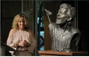  ?? (NWa democrat-Gazette file photo) ?? Amy Helm, daughter of musician Levon Helm, looks at a bronze bust of her late father after it was unveiled in 2018. The bust was placed near helm’s boyhood home. The house was moved from Turkey scratch to downtown Marvell, where amy helm will perform at the Levon helm downhome Jubilee on sunday.