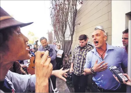  ?? Photograph­s by Genaro Molina
Los Angeles Times ?? MARK LIPMAN, left, of the activist group People Organized for Westside Renewal, argues with vacation rental operator Sebastian de Kleer, who says: “I’ve received permits. I’ve been paying taxes. Why would the city want to put me out of business?”