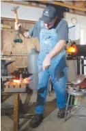  ?? STAFF PHOTO BY MEGHAN BROWN ?? Ryan Johnson, owner of RMJ Forge and RMJ Tactical, forges a tomahawk at his shop in Hixson in 2008. Johnson’s tactical tomahawks are used by the military, law enforcemen­t and fire department­s.