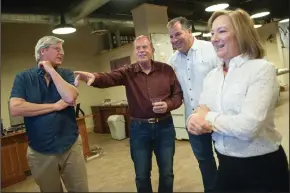  ?? BEA AHBECK/NEWS-SENTINEL ?? Mark Chandler, who won re-election to the Lodi City Council, council member Doug Kuehne, running unopposed, Michael Carouba and Jan Chandler check numbers at an election results viewing party for the Measure L and Mark Chandler campaigns in Lodi on Tuesday.