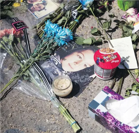  ?? TROY FLEECE ?? Friends are leaving tributes in the parking lot of the South Leisure Centre in memory of Athan McEwen, 15, who died there Friday night.