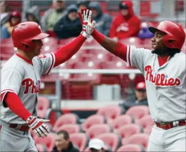  ?? JOHN MINCHILLO — THE ASSOCIATED PRESS ?? The Philadelph­ia Phillies’ Daniel Nava, left, celebrates with Odubel Herrera after hitting a solo home run off Cincinnati Reds starting pitcher Rookie Davis in the first inning of Thursday’s game. Nava hit two home runs in the loss.