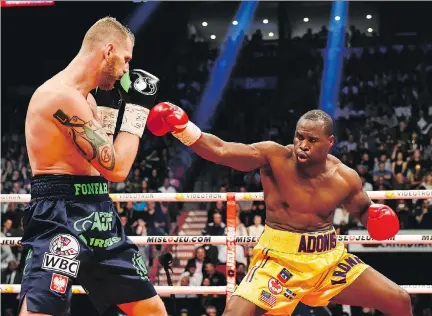  ?? MINAS PANAGIOTAK­IS/GETTY IMAGES/FILES ?? Adonis Stevenson, right, fighting Andrzej Fonfara last June, will battle Badou Jack in Toronto on Saturday.