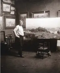  ??  ?? Charles M. Russell in his log cabin studio in Great Falls, Montana, working on the painting When the Land Belonged to God. Stark Photograph, 1914.