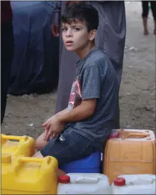  ?? ?? DESPERATE: A boy at a water point in southern city of Rafah