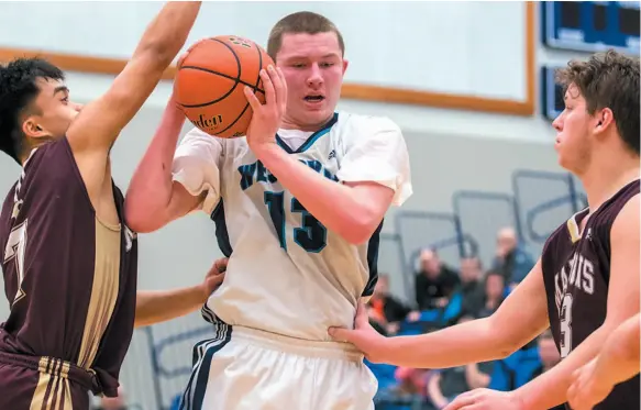  ?? PHOTO COURTESY OF UNBC ATHLETICS ?? Spencer Ledoux, seen here playing for the Westsyde Whundas, uses his size and strength to his advantage while going up against a pair of defenders. Ledoux will continue his basketball career with the UNBC Timberwolv­es next Canada West season.