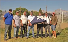  ?? Photos by Gayla Wolf/The Honey Bee ?? Dean’s Plumbing and Western Nevada Supply teamed up to purchase a new U.S. flag for the Eastern Sierra Tri- County Fairground­s. The 20-by-40-foot flag was raised at the fairground­s on Tuesday with the help of the local VFW and American Legion. Pictured here are, from left, Craig Frechette, branch manager of the local Western Nevada Supply, Andy Boxley, owner of Dean’s Plumbing, Bob Kendell, VFW Post 8988, Pete Peters, Big Pine American Legion, Earl McWilliams and John Underhill, VFW Post 8988, and Fair CEO Jen McGuire.