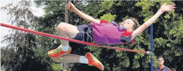  ??  ?? Up and over: This St Neots pupil clears his height in the high jump at the school’s successful Sports Day, held in glorious sunshine