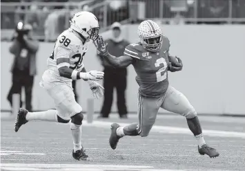  ?? JAY LAPRETE AP ?? Ohio State running back J.K. Dobbins, right, races past Penn State defensive back Lamont Wade in the first half Saturday. Dobbins gained 157 yards and scored two touchdowns as the Buckeyes edged the Nittany Lions.