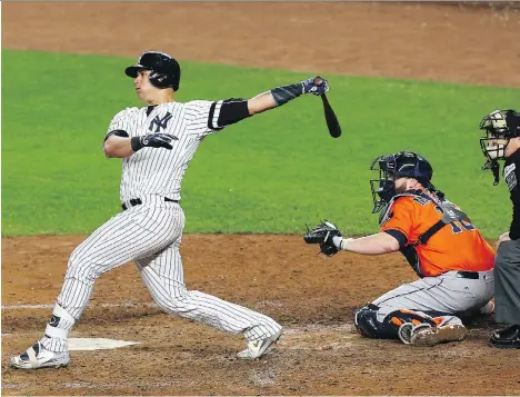  ?? MIKE STOBE/GETTY IMAGES ?? New York Yankees catcher Gary Sanchez hits a solo home run during the seventh inning against the Houston Astros in Game 5 of the ALCS on Wednesday in New York. After winning all three of the series’ games in the Bronx, the Yankees go back to Houston...