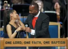  ?? PAUL SANCYA — ASSOCIATED PRESS ?? Singer Ariana Grande, left, shares a light moment with Bishop Charles H. Ellis during Friday’s funeral service for Aretha Franklin at Greater Grace Temple, Friday in Detroit.