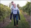  ?? JENN PRINE — PJ PAINTER VIA AP ?? PJ, top, and Ryan take a fun stroll through the grape vines of Atwood Hill Winery in Atwood, Ky., for an engagement photo.