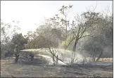  ?? CARIN DORGHALLI — ENTERPRISE­RECORD ?? Left to right, Vashaun Mickens and Jose Nuno of Cal Fire-Butte County put out hotspots from a fire Thursday near Grand Avenue in Oroville.