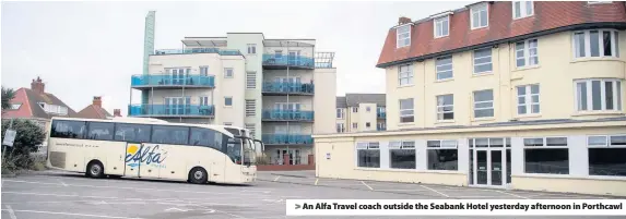  ??  ?? > An Alfa Travel coach outside the Seabank Hotel yesterday afternoon in Porthcawl