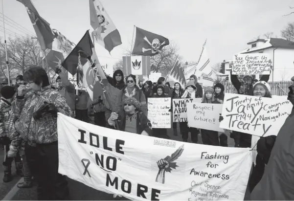  ?? DAVE CHIDLEY / THE CANADIAN PRESS ?? Aboriginal protesters and supporters of the Idle No More movement march on their way to blocking the Blue Water Bridge to the United States in Sarnia, Ont., on Jan. 5.