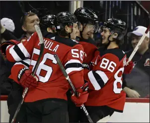  ?? ADAM HUNGER — THE ASSOCIATED PRESS FILE ?? New Jersey defenseman Damon Severson (28) celebrates with teammates after scoring a goal against the Edmonton Oilers during on Monday.