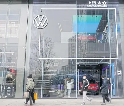  ?? REUTERS ?? People walk past an ID. Store X showroom of SAIC Volkswagen in Chengdu, Sichuan province.