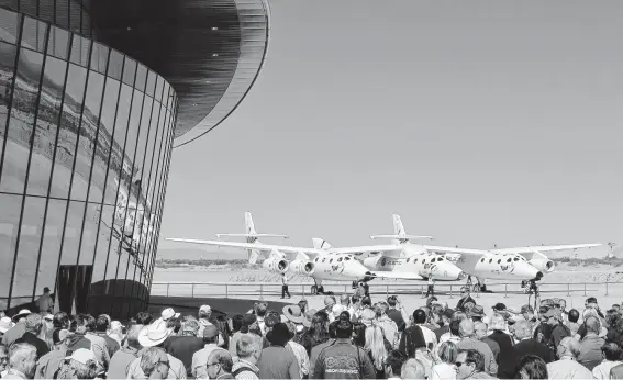  ?? Susan Montoya Bryan / Associated Press file photo ?? A crowd gathers for a 2011 Virgin Galactic ceremony. Founder Richard Branson said in May the company is beginning final preparatio­ns for commercial space flights.