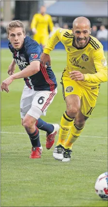  ?? [JOSHUA A. BICKEL/DISPATCH] ?? Crew forward Federico Higuain moves to the ball in front of Revolution midfielder Scott Caldwell during the first half. Shots: Columbus 12; New England 18.
Columbus 6; New York 5. Columbus, Steffen 5; New England, Cropper 4. Columbus 11; New England...