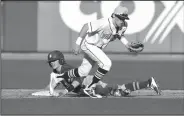  ?? NWA Democrat-Gazette/J.T. WAMPLER ?? Springdale Har-Ber’s Mac McCroskey can’t keep a hold of the ball while Rogers’ Brandon Husted slides to second base Monday at Arvest Ballpark in Springdale. Rogers beat the Wildcats 1-0.