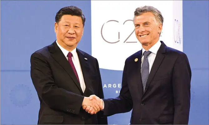  ??  ?? Chinese President Xi Jinping is welcomed by Argentina’s President Mauricio Macri at Costa Salguero in Buenos Aires during the G20 Leaders’ Summit on Friday.