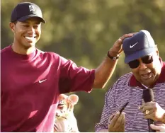  ??  ?? GOOD TIME . . . Tiger Woods shares a laugh with his father Earl Woods (right), before his passing back in 2006.