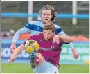  ??  ?? Arbroath’s Jason Thomson flicks the ball over Robbie Muirhead