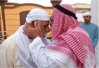  ?? Jeff Topping / The National ?? Saeed Ali Saeed Al Yamahi, right, whose son was killed in a road accident in 2010, offers his condolence­s to Saeed Al Yamahi, whose sons Sultan and Khaled drowned in 2011. The family of the teenage brothers have returned to legal action