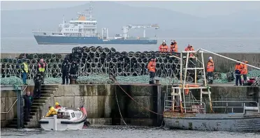  ??  ?? Darkest day: Emergency services preparing to board rescue vessel Granuaile yesterday