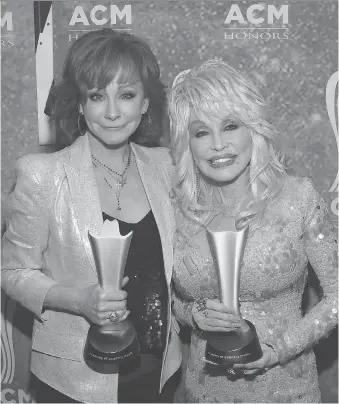  ?? RICK DIAMOND/GETTY IMAGES ?? Music legends Reba McEntire, left, and Dolly Parton attend the 11th annual Academy of Country Music Honors in Nashville Wednesday.