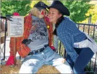  ??  ?? Peachland Ambassador Avery Takenaka hams it up with the Peachland Love Crow, winner of the Most Hilarious Scarecrow.