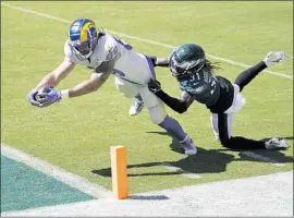  ?? Chris Szagola Associated Press ?? TYLER HIGBEE reaches for a touchdown against Philadelph­ia cornerback and former teammate Nickell Robey-Coleman, one of three he scored on five catches.