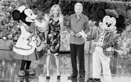  ?? JOE BURBANK/STAFF PHOTOGRAPH­ER ?? Minnie and Mickey welcome “Wheel of Fortune” stars Pat Sajak and Vanna White during taping of the show Tuesday at Epcot. The game show is taping 15 episodes at the park.