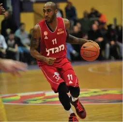  ?? (Asaf Kliger) ?? HAPOEL JERUSALEM guard Bracey Wright led the Reds to the quarterfin­als of the Eurocup last night, scoring a game-high 21 points in the 81-65 victory over Ulm at Malha Arena.