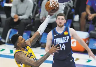  ?? Sue Ogrocki / Associated Press ?? The Warriors’ Kent Bazemore shoots in front of the Thunder’s Svi Mykhailiuk in the second half of Golden State’s 147109 rout in Oklahoma City. Bazemore scored 15 points in 21 minutes.